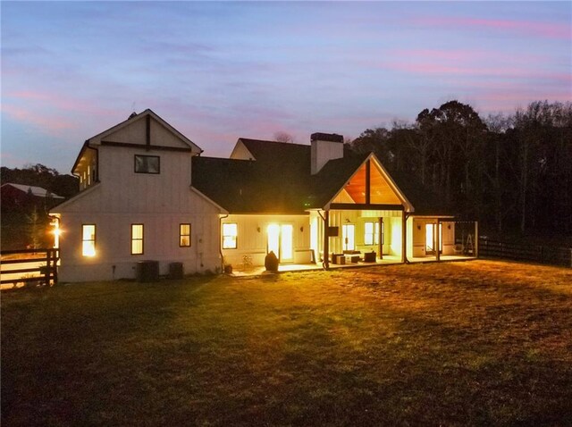 view of back house at dusk