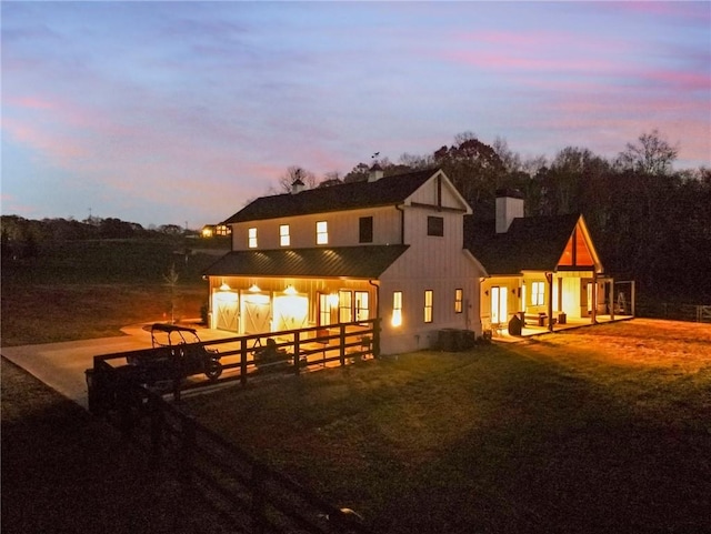 view of back house at dusk