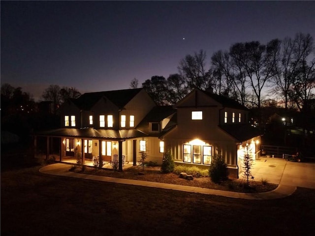 back house at dusk with covered porch