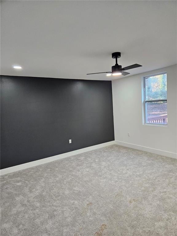 empty room featuring carpet flooring and ceiling fan