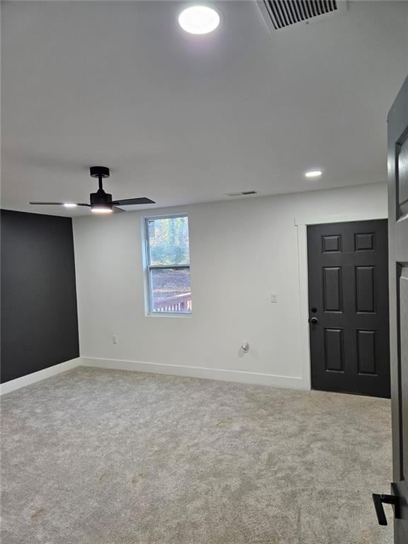 unfurnished room with ceiling fan and light colored carpet