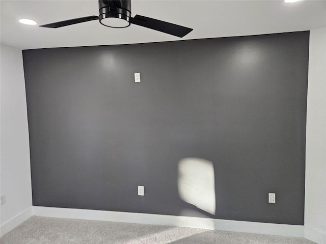 empty room featuring ceiling fan and light colored carpet