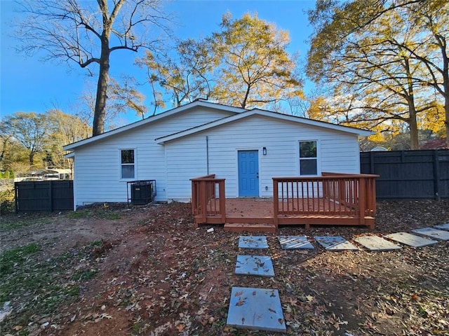 rear view of house featuring cooling unit and a deck