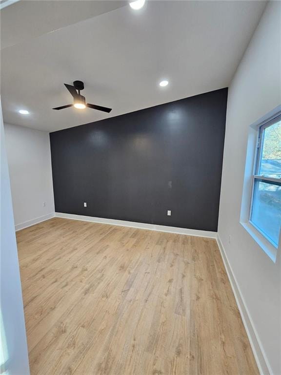 spare room with ceiling fan and light hardwood / wood-style flooring