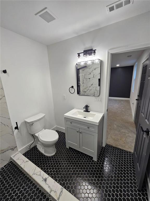 bathroom featuring vanity and toilet