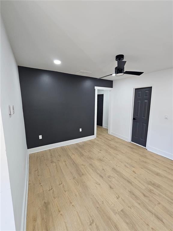 empty room with light wood-type flooring and ceiling fan