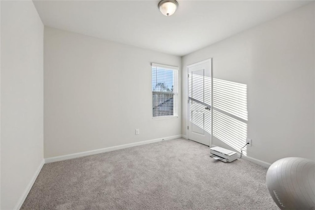 unfurnished room featuring light colored carpet