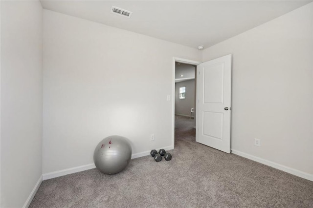 workout area featuring light colored carpet