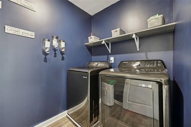 laundry area featuring washing machine and dryer and dark wood-type flooring