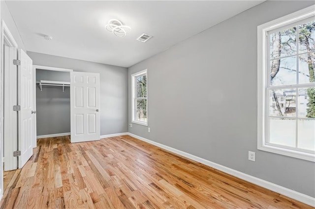 unfurnished bedroom featuring light hardwood / wood-style flooring and a closet