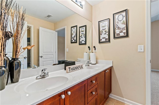 full bathroom with double vanity, baseboards, visible vents, and a sink