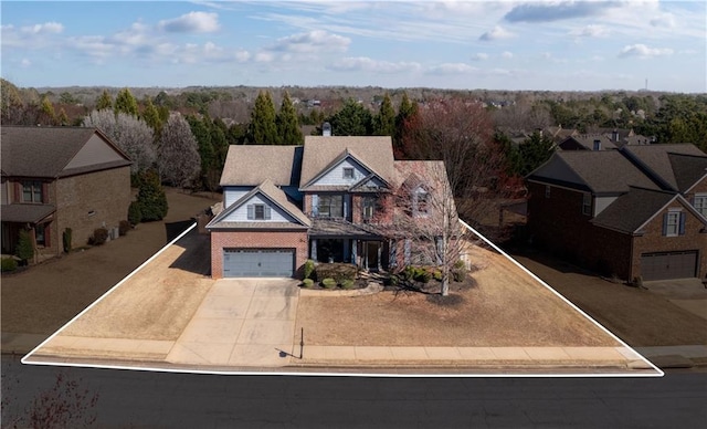 view of front of house featuring concrete driveway and a garage