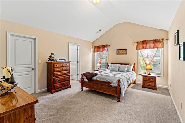 bedroom with visible vents, lofted ceiling, multiple windows, and light carpet