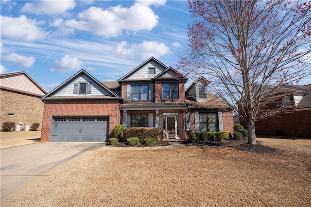 view of front of property featuring brick siding, an attached garage, and driveway