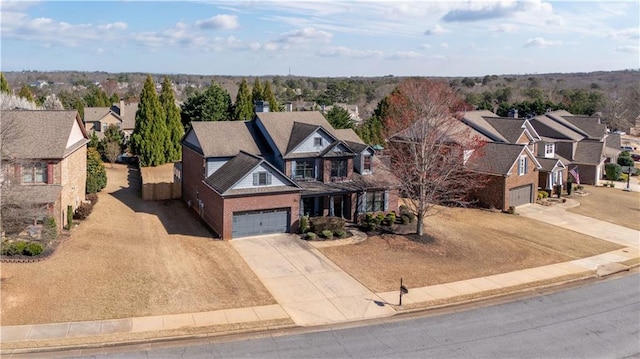 view of front of property featuring a residential view, driveway, and an attached garage