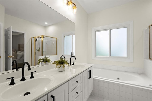 bathroom featuring a garden tub, a shower stall, and double vanity