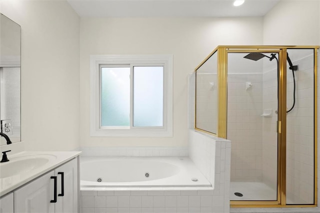 full bath featuring a shower stall, a tub with jets, and vanity