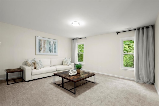 living room featuring baseboards and carpet floors