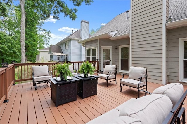 wooden deck with an outdoor living space