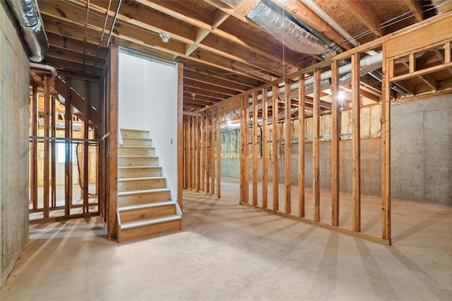 unfinished basement featuring stairway