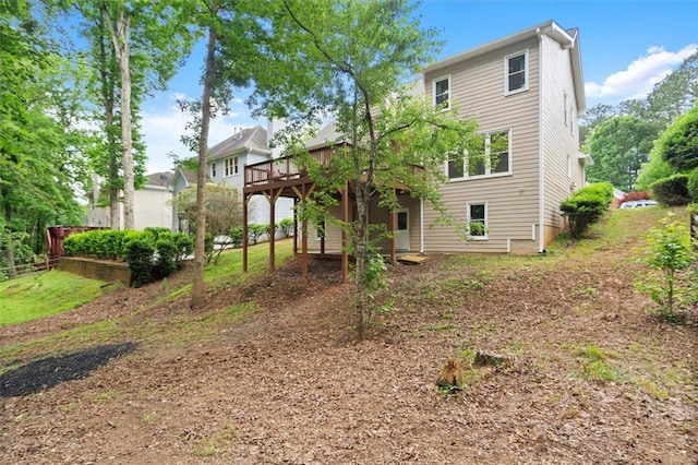 rear view of house with a wooden deck