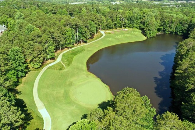 aerial view of property and surrounding area with a large body of water and a forest