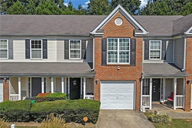 view of front of house with a garage, brick siding, a porch, and concrete driveway