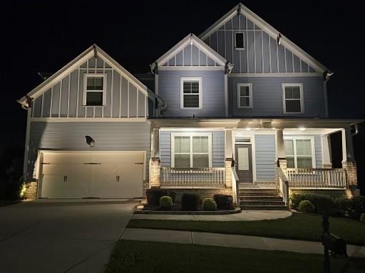 craftsman inspired home with a garage and a porch