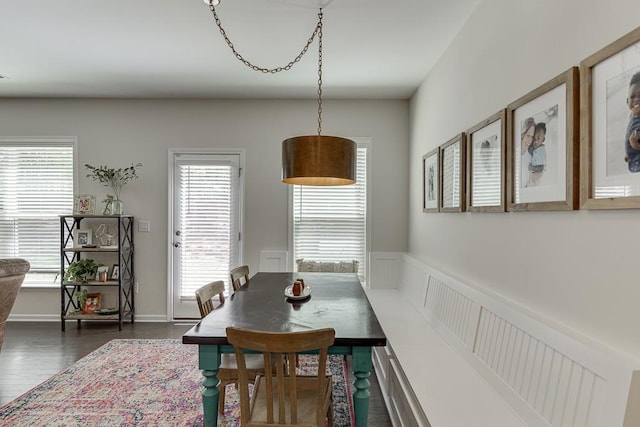 dining room with plenty of natural light and dark wood-type flooring