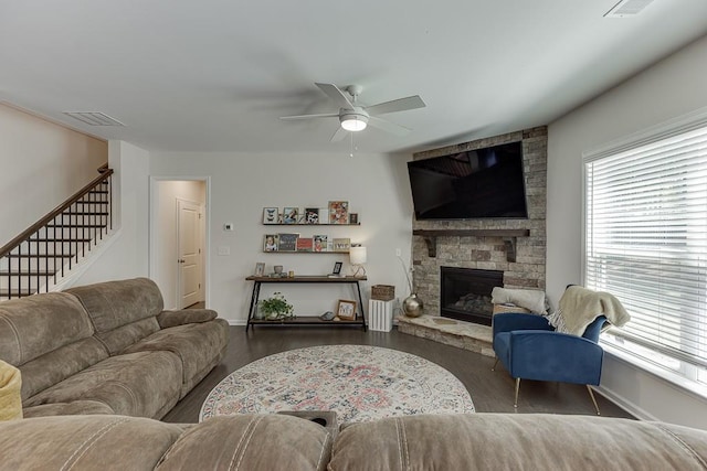 living room featuring stairway, baseboards, a ceiling fan, and wood finished floors