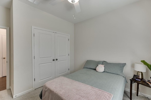 bedroom with visible vents, baseboards, a closet, and light colored carpet