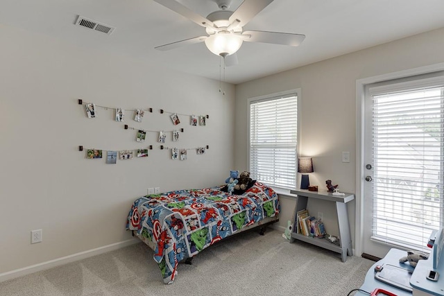 carpeted bedroom with visible vents, baseboards, and ceiling fan