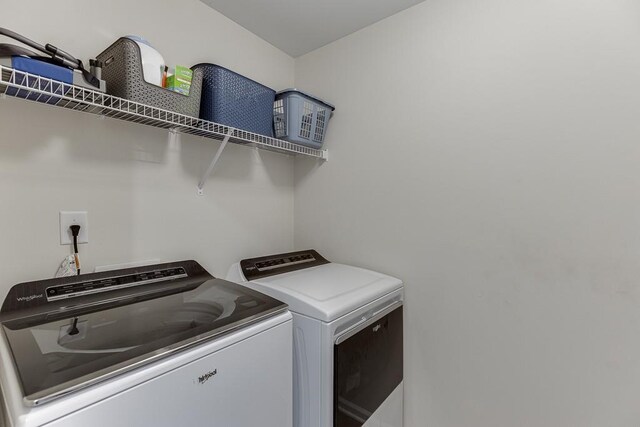 washroom with separate washer and dryer and laundry area