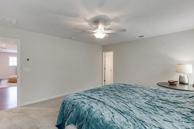 bedroom with visible vents, carpet, baseboards, and ceiling fan