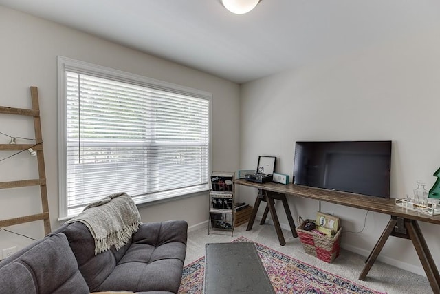 carpeted home office featuring baseboards