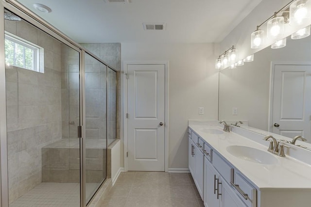 full bath featuring a sink, tile patterned floors, and a stall shower