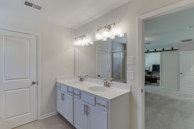 full bath featuring visible vents, a sink, and a stall shower