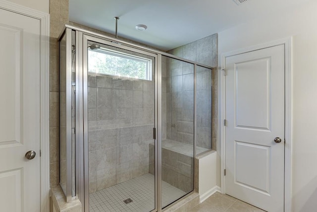 full bath featuring tile patterned floors and a stall shower