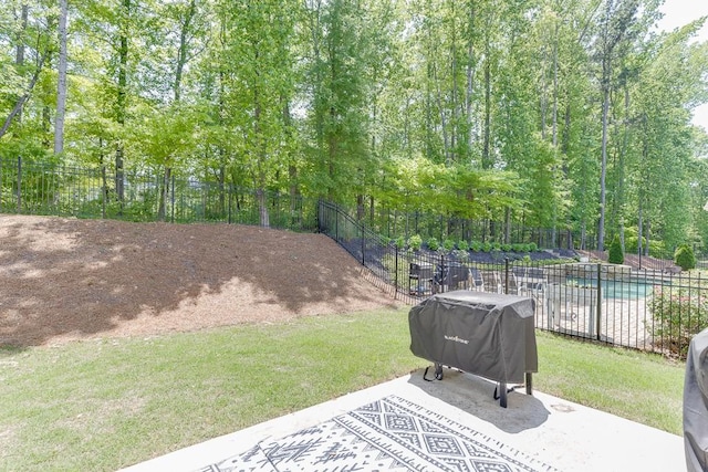 view of patio / terrace with fence, a grill, and an outdoor pool