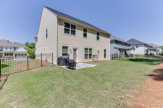 rear view of house with a lawn, a fenced backyard, and a patio area
