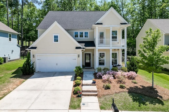 view of front of home with a shingled roof, a porch, driveway, and a balcony