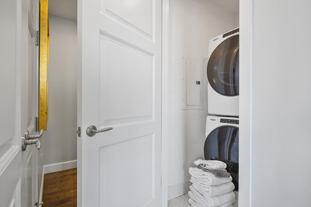 1820 Peachtree St Unit 614, Atlanta, GA 30309 - laundry room with stacked washer / drying machine, baseboards, and wood finished floors