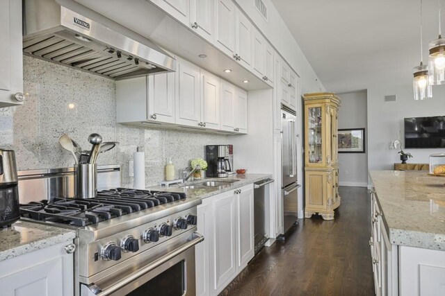1820 Peachtree St Unit 614, Atlanta, GA 30309 - kitchen with range hood, premium appliances, a sink, white cabinetry, and decorative backsplash