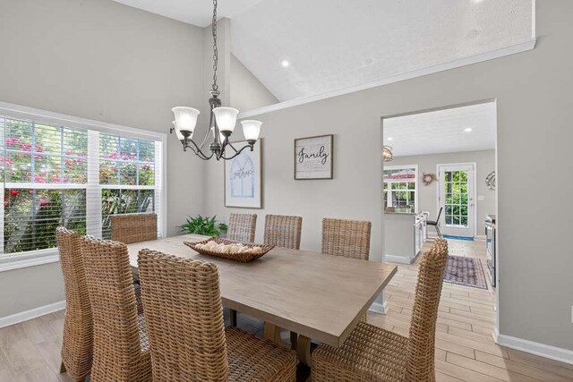 734 Evergreen Dr, Winder, GA 30680 - dining room with a chandelier, light wood finished floors, high vaulted ceiling, and recessed lighting
