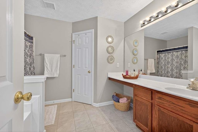 734 Evergreen Dr, Winder, GA 30680 - full bath with vanity, tile patterned flooring, and a textured ceiling