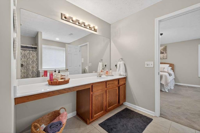 734 Evergreen Dr, Winder, GA 30680 - ensuite bathroom with vanity, tile patterned floors, and a textured ceiling