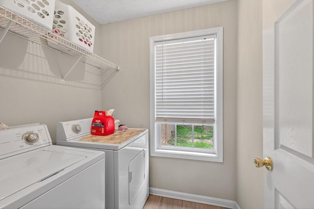 734 Evergreen Dr, Winder, GA 30680 - laundry area with washing machine and clothes dryer and light wood finished floors