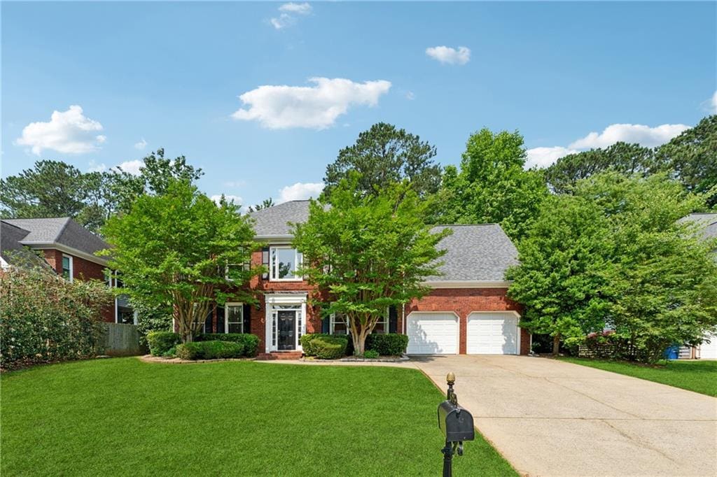 5013 Kendall Sta NW, Acworth, GA 30102 - obstructed view of property featuring a garage, driveway, and a front yard