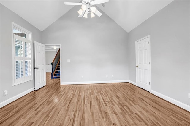 unfurnished living room featuring light wood-type flooring, ceiling fan, and high vaulted ceiling