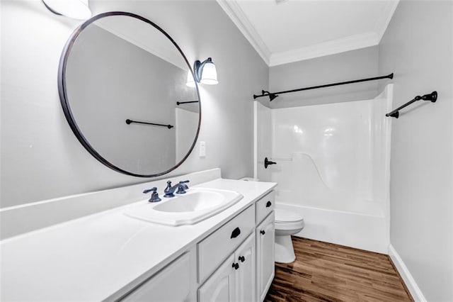 full bathroom with toilet, hardwood / wood-style flooring, bathing tub / shower combination, ornamental molding, and vanity